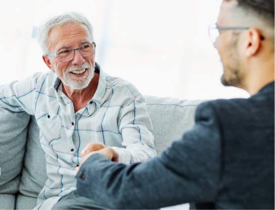 Senior man shaking hands with business man